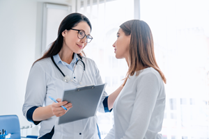 female doctor talking to female patient