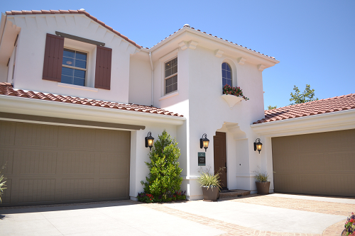 a spanish style home with two garages